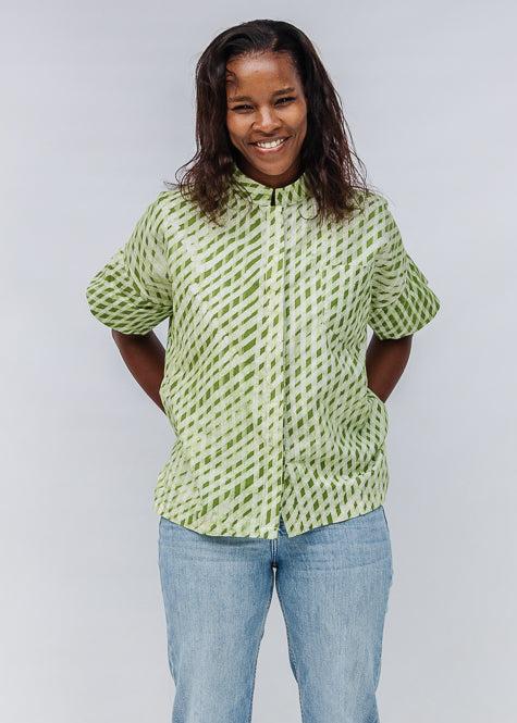 Model wearing green and white plaid shirt.