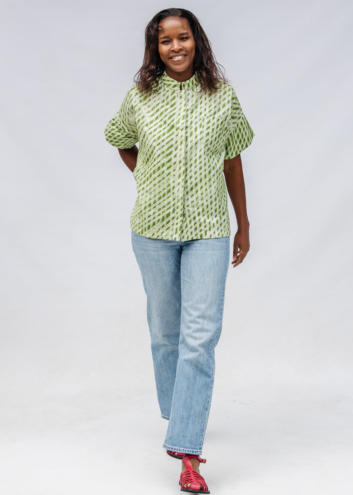 Model wearing green and white plaid shirt.