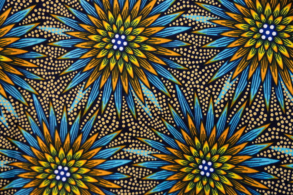 Close up display of blue, yellow, orange and black geometric print dress, fabric.