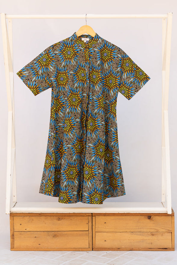 Display of blue, yellow, orange and black geometric print dress.
