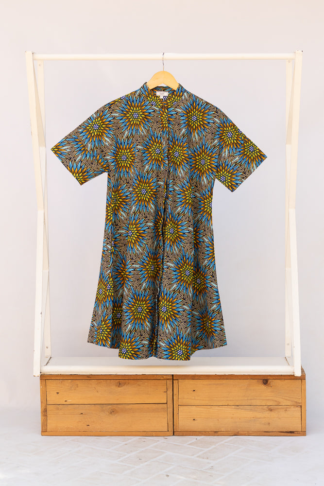 Display of blue, yellow, orange and black geometric print dress.