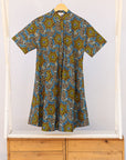 Display of blue, yellow, orange and black geometric print dress.