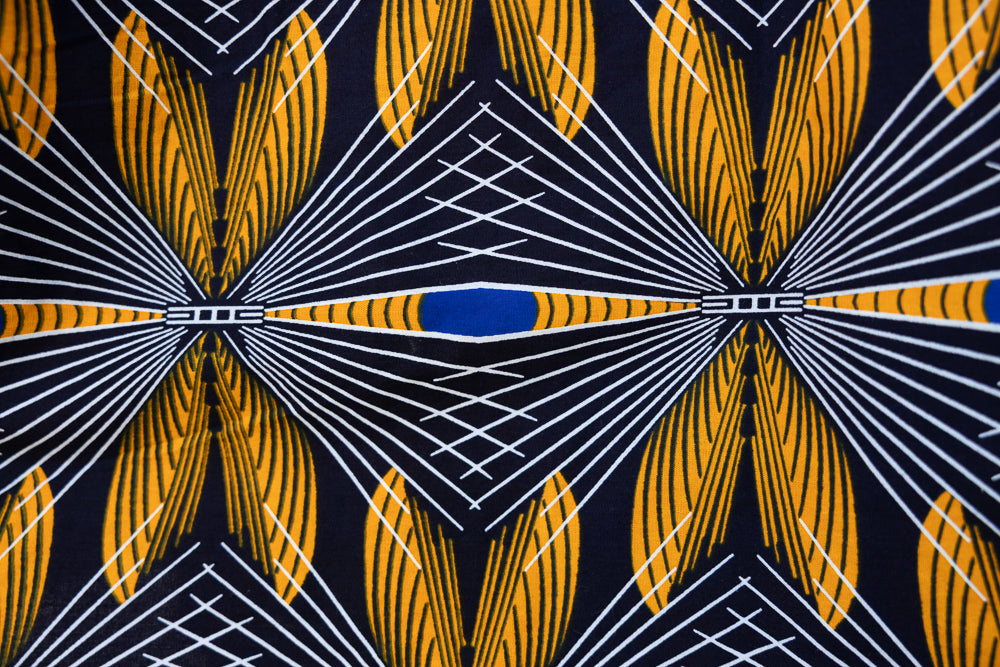 Close up display of blue, white and yellow abstract print shirt, fabric.