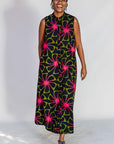 Model wearing navy and green dress with pink floral print.
