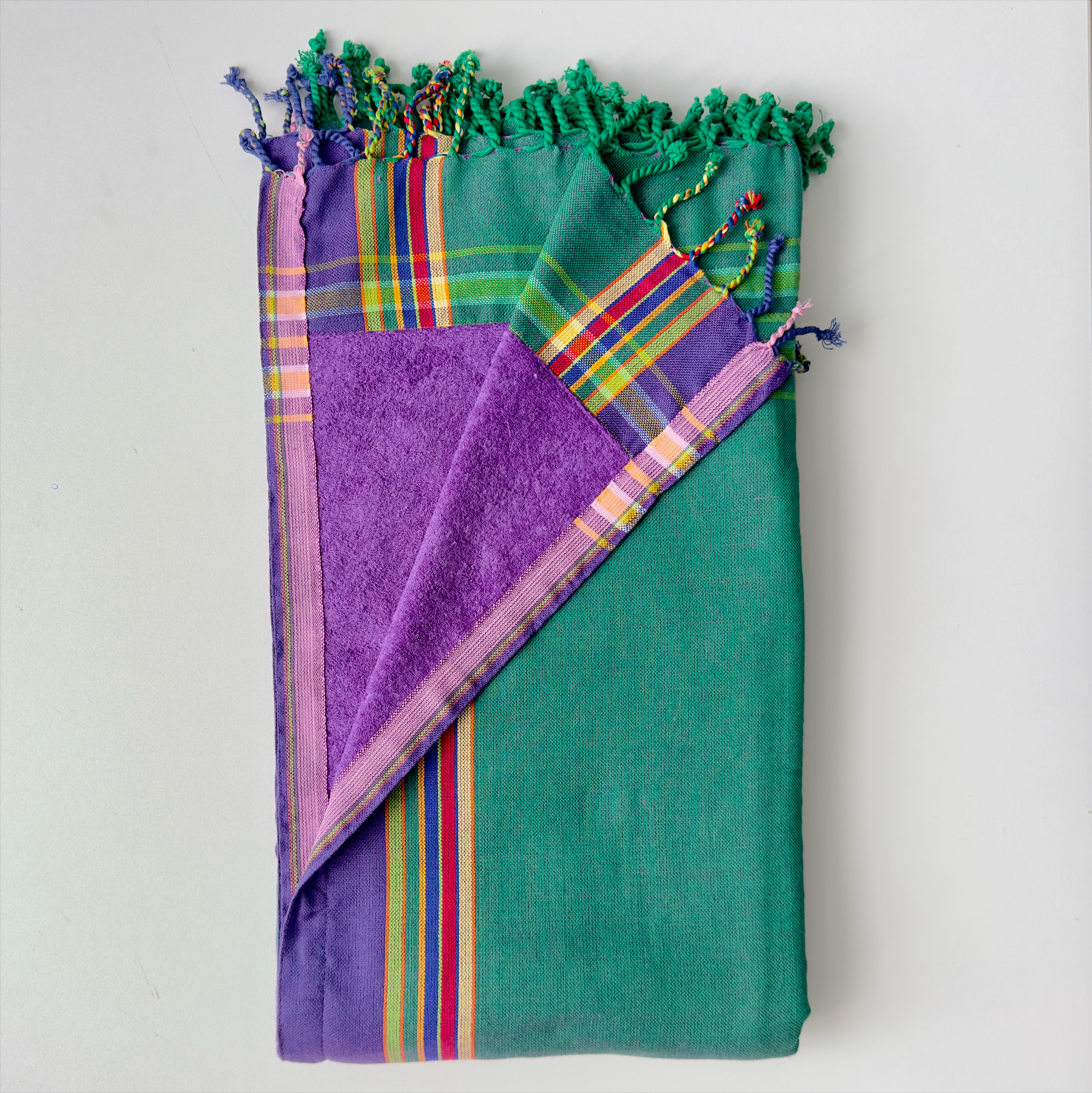 teal-green, purple kikoi towel