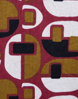Close up display of burgundy, mustard and black geometric print dress, fabric.
