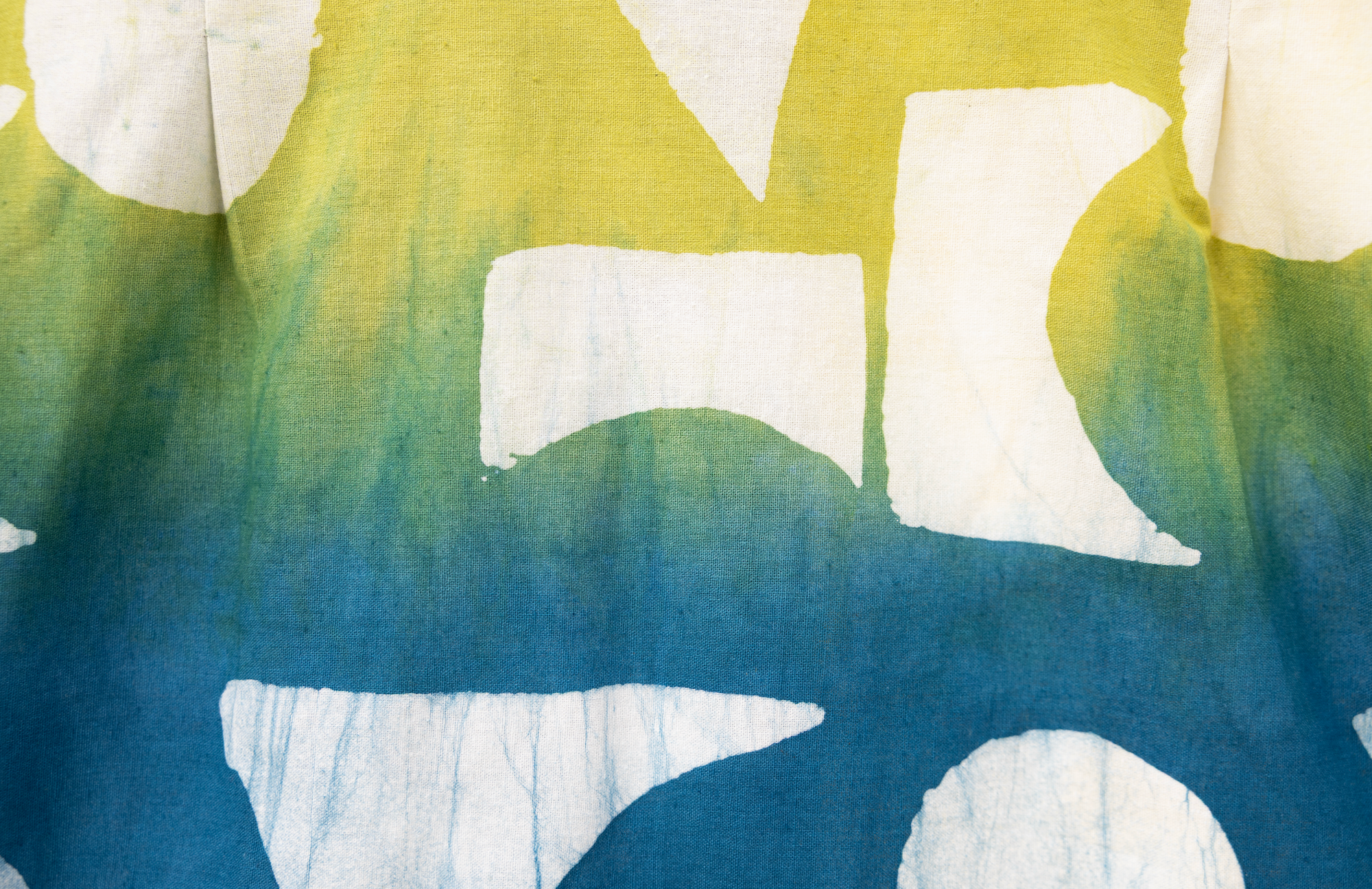 Close up display of mutlicolored batik shortsleeved shirt, fabric.