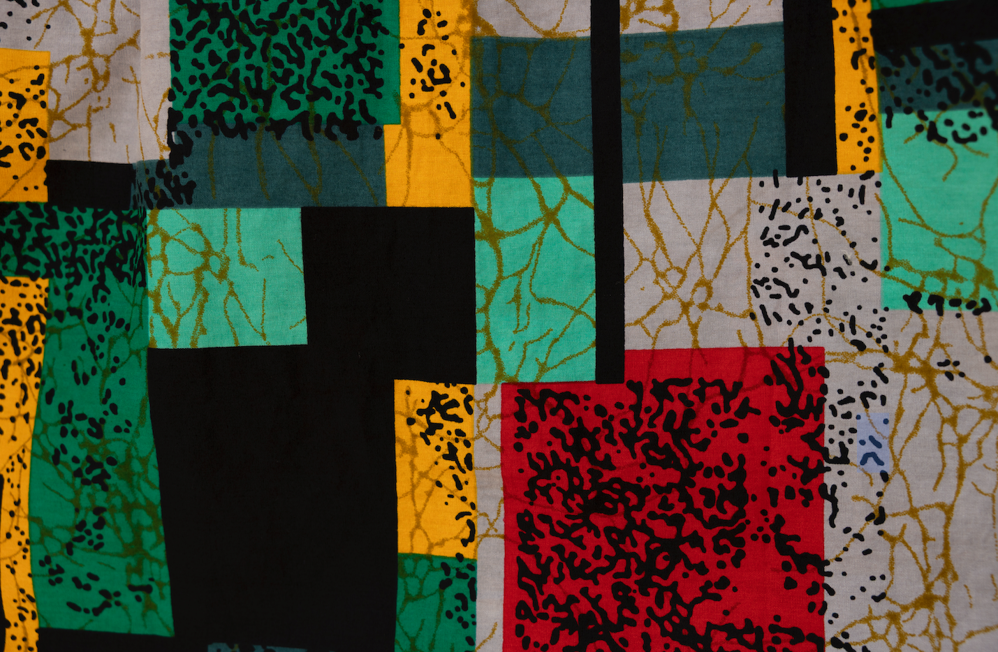 Close up display of mutlicolor abstract print shirt.