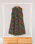 Display of black sleeveless dress with rainbow circle print.
