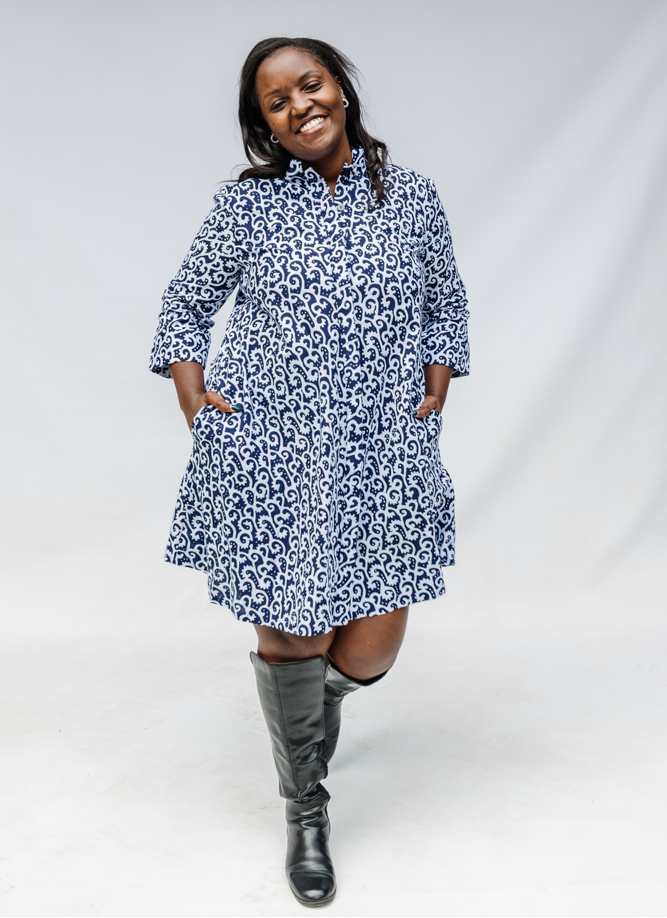 Model wearing blue and white swirl print dress.