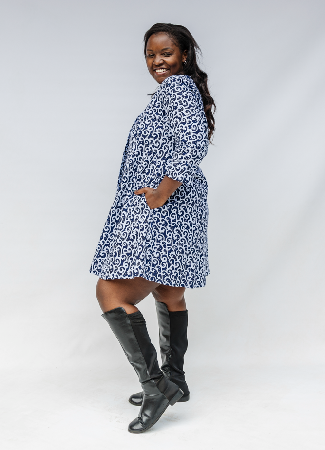 Model wearing blue and white swirl print dress.