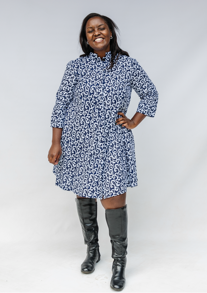 Model wearing blue and white swirl print dress.