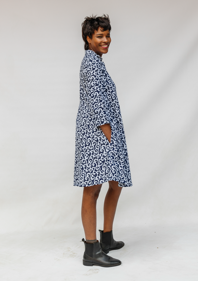 Model wearing blue and white swirl print dress.
