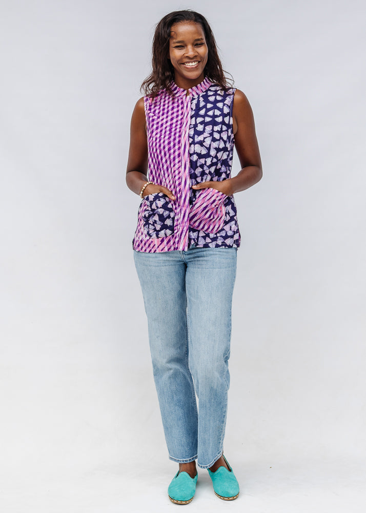 Model wearing purple, pink and white geometric print, patchwork sleeveless shirt.