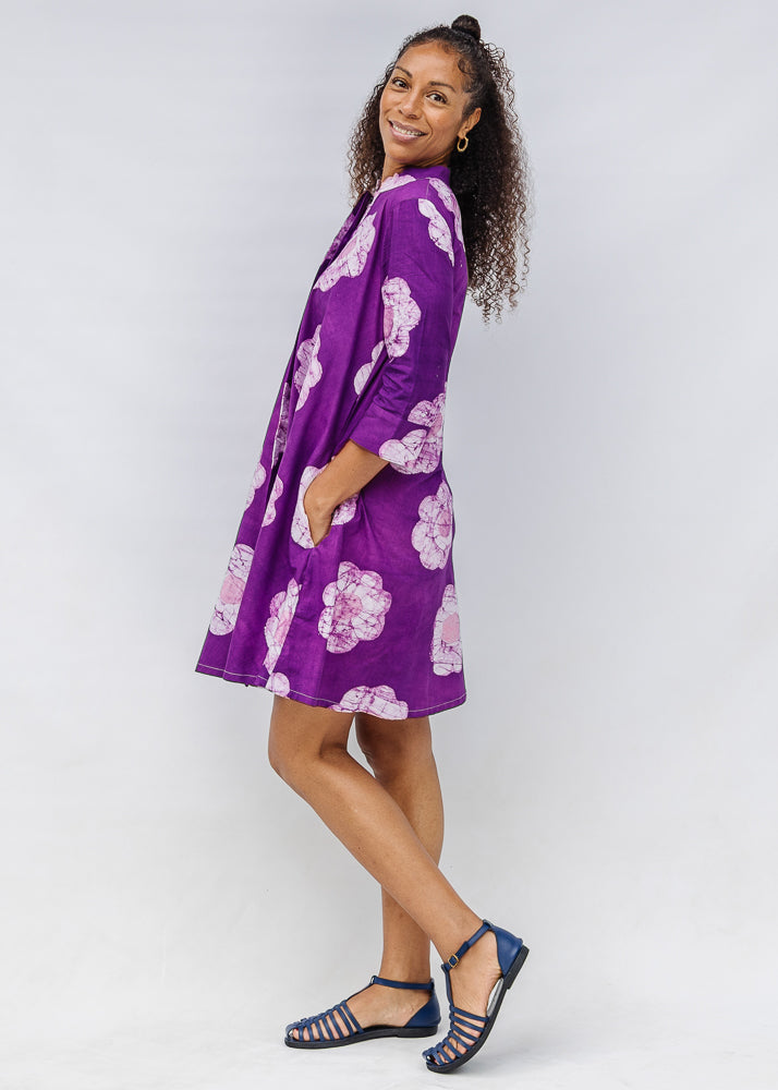 Model wearing purple and white floral print dress.