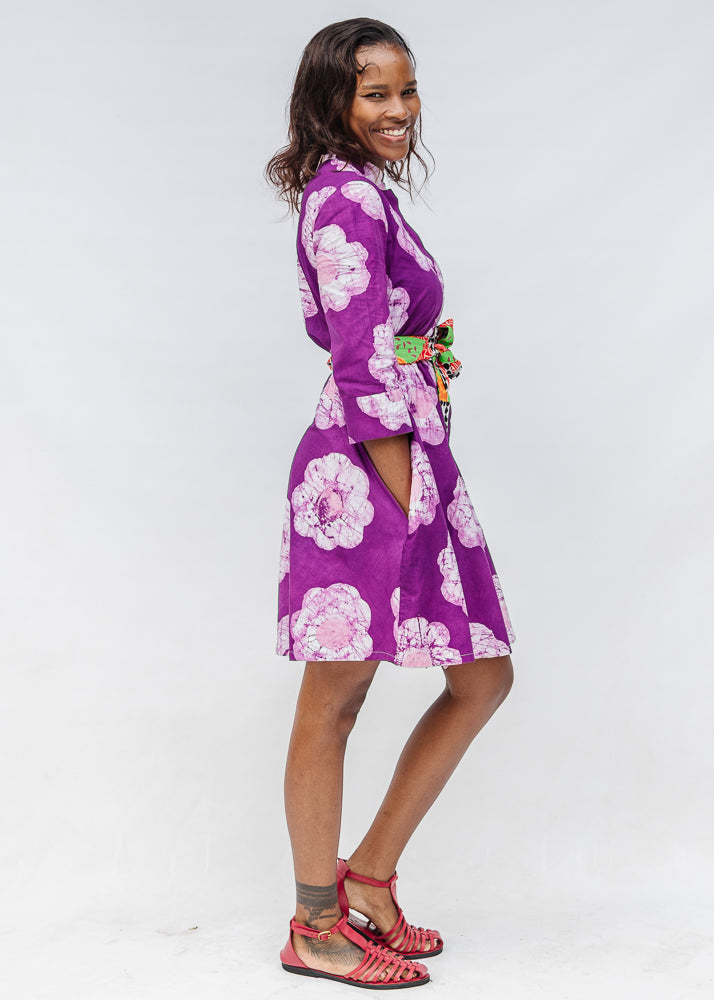 Model wearing purple and white floral print dress.