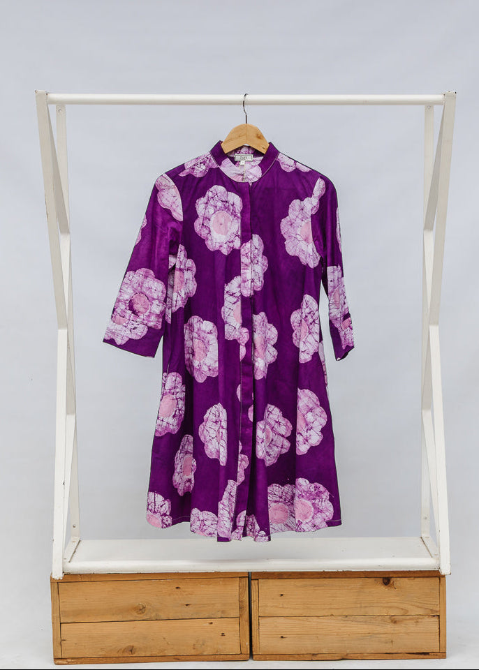 Display of purple and white floral print dress.