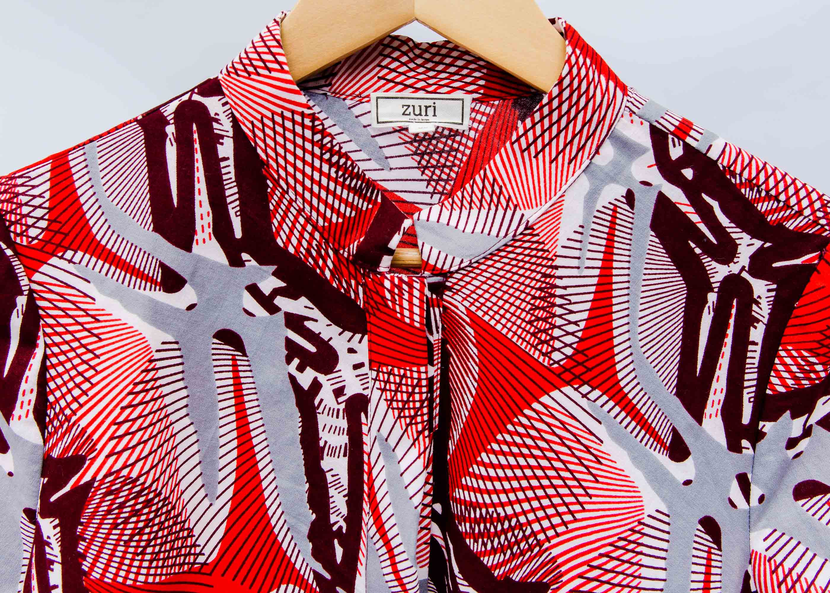 Display of a red, grey and maroon geometric shirt dress