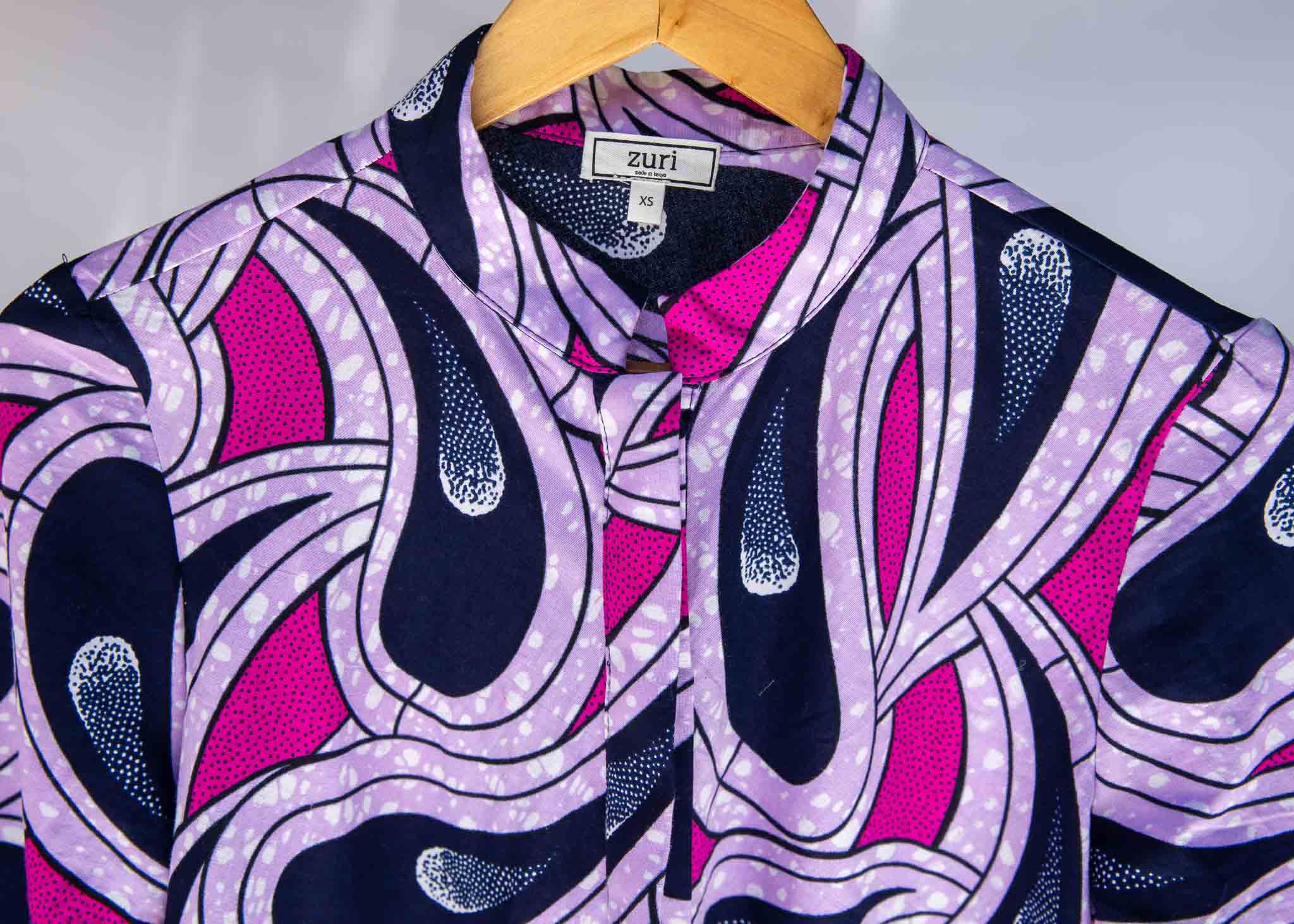 Display of purple and pink geometric print dress.