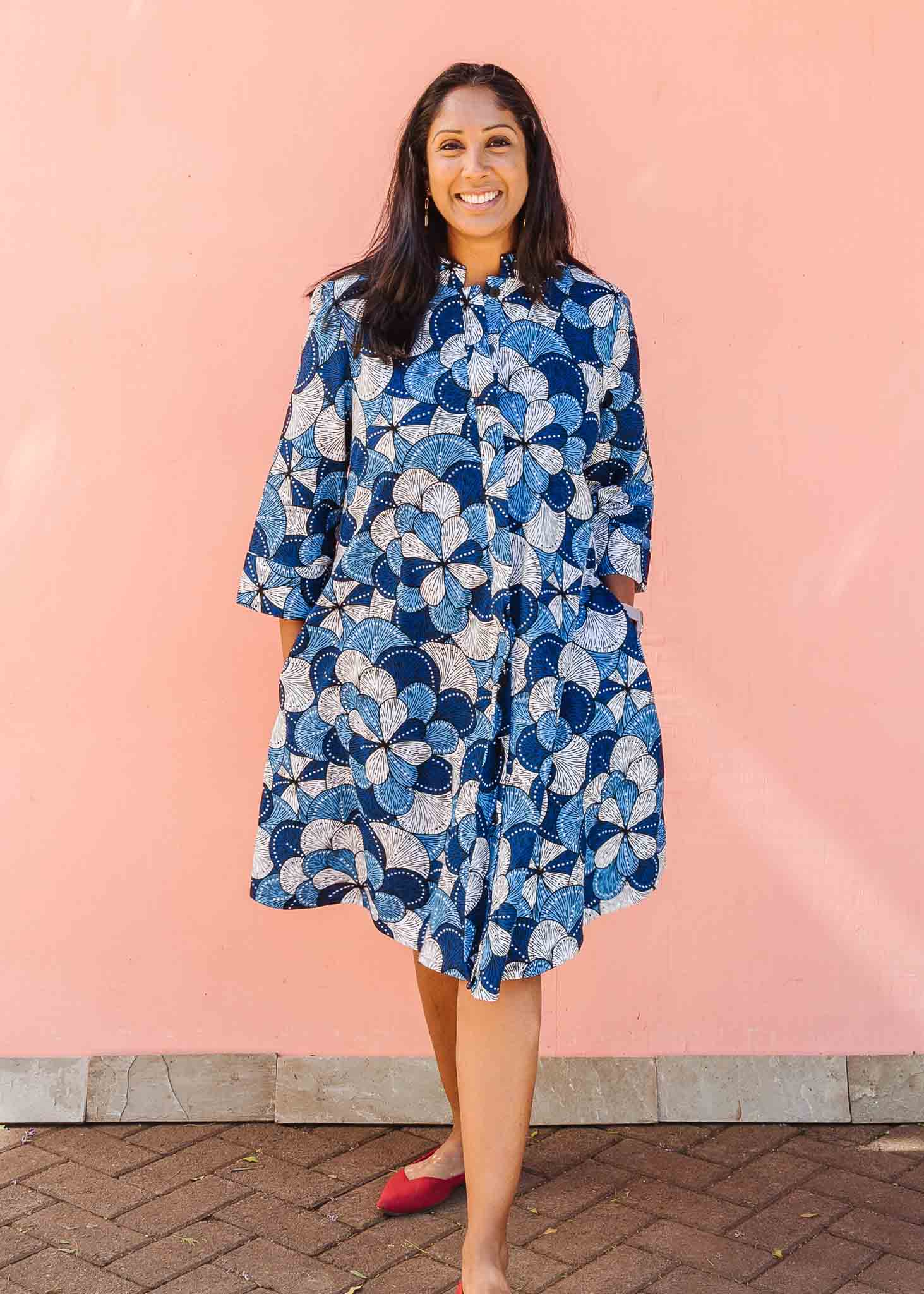 Model wearing blue and white floral print dress.