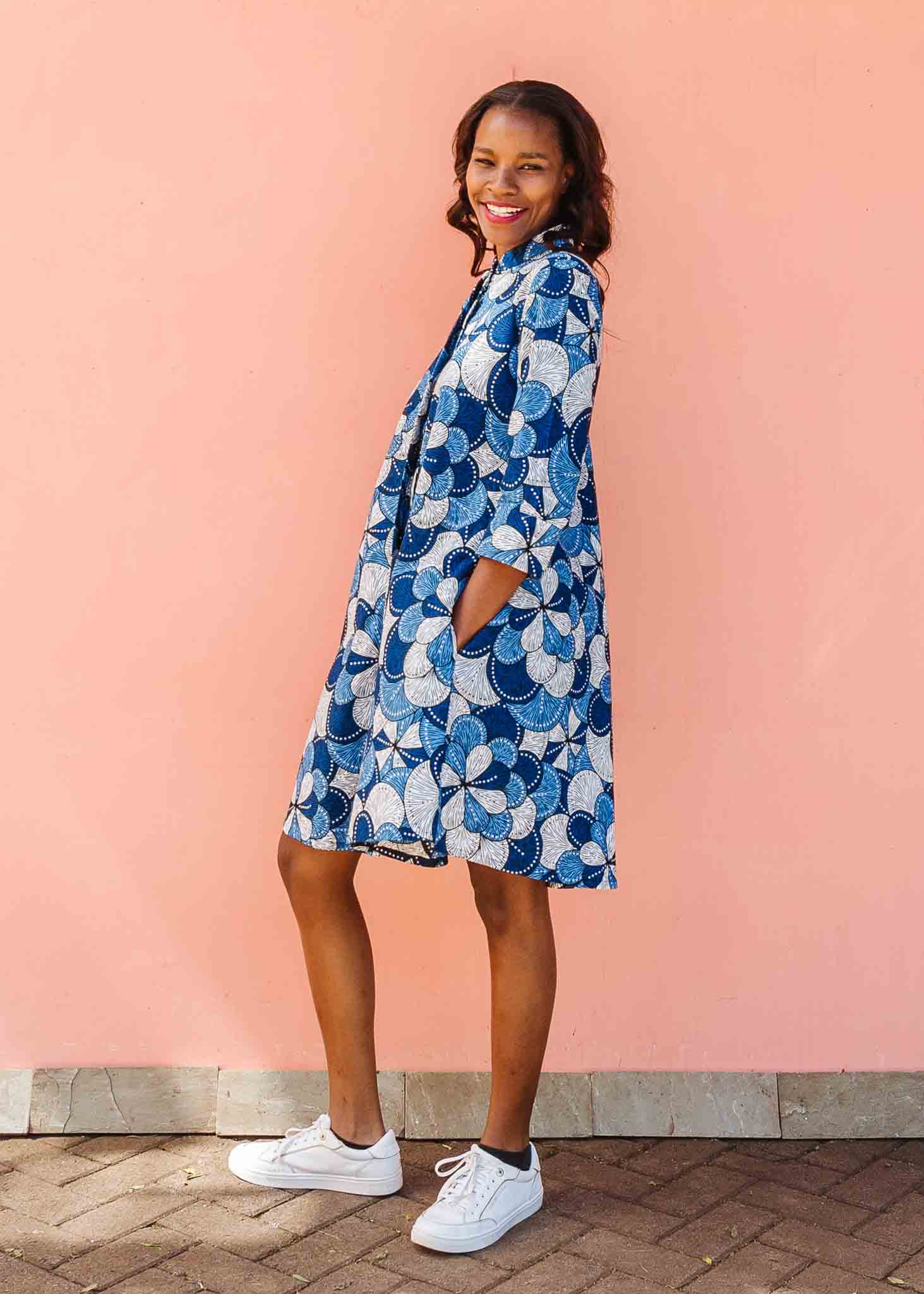 Model wearing blue and white floral print dress.