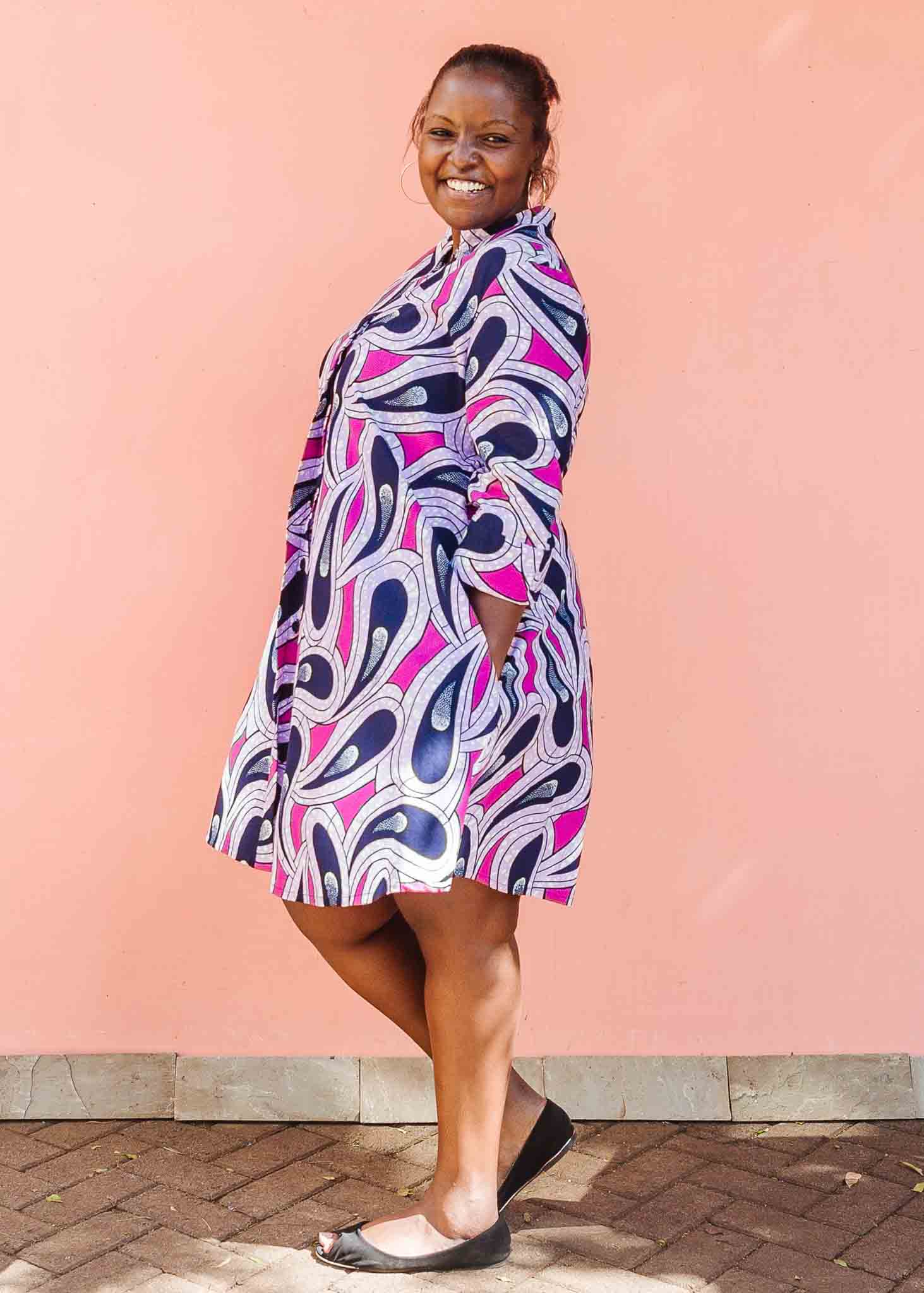 Model wearing purple and pink geometric print dress.