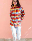 Model wearing rainbow dot print long sleeve shirt.