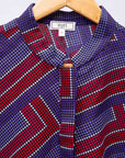 detail of a blue, red and lavender geometric shirt dress