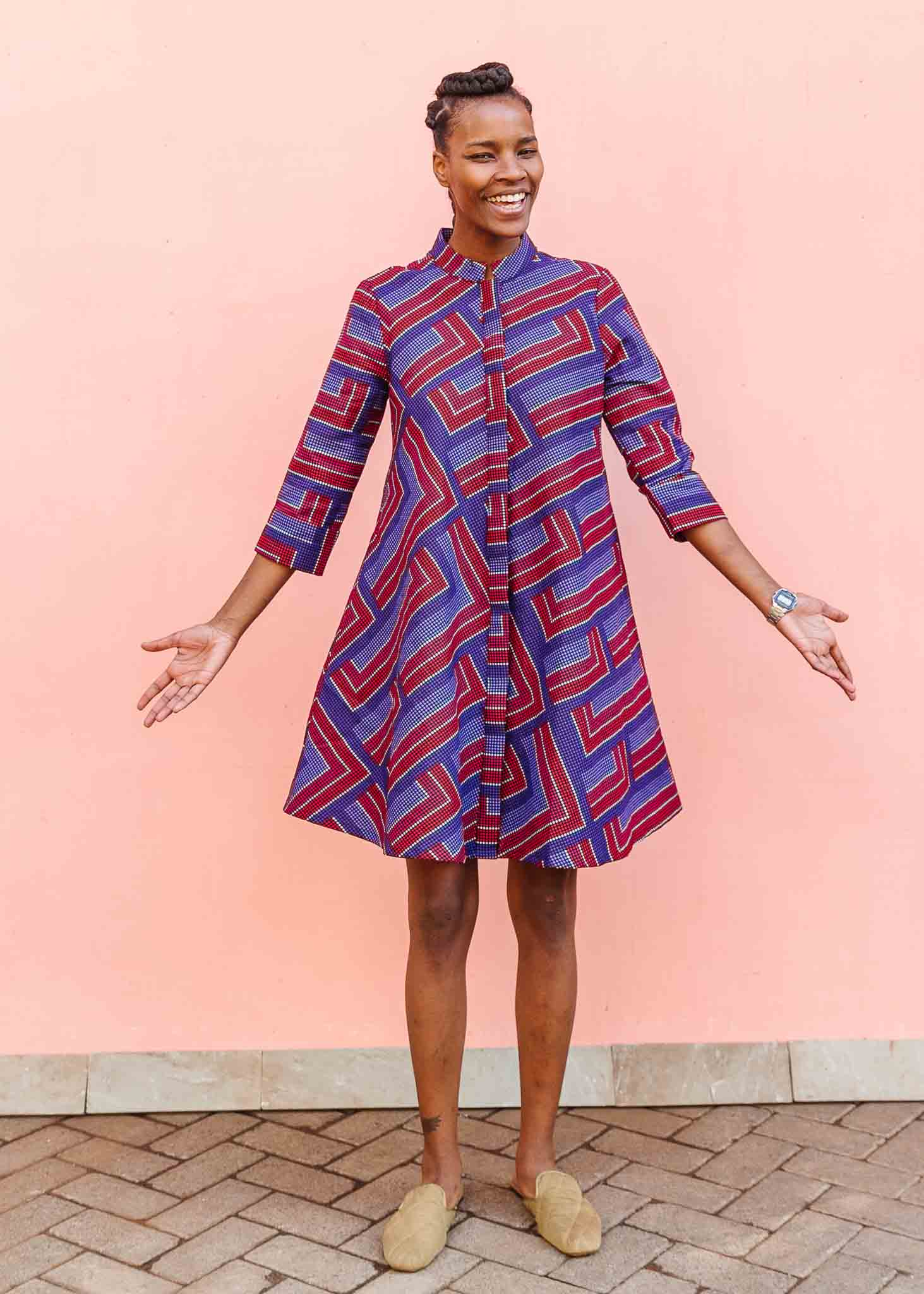 model wearing a blue, red and lavender geometric shirt dress