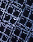Close up display of black and white square batik dress