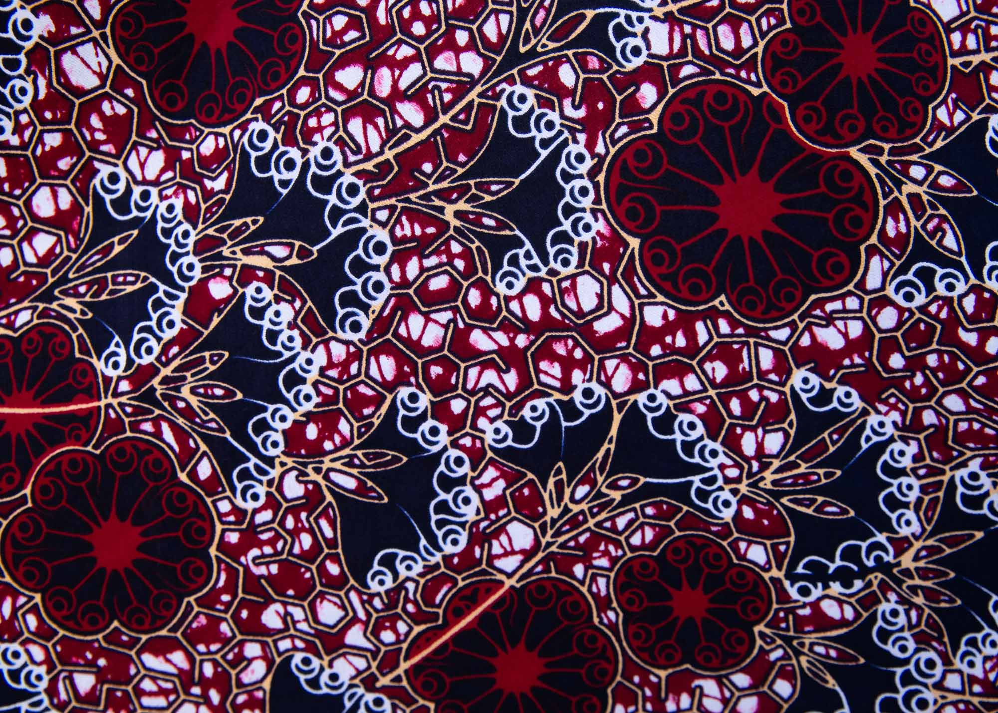 Close up display of burgundy, white and navy blue floral print dress
