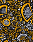 Close up display of black dress with white and yellow botanical print