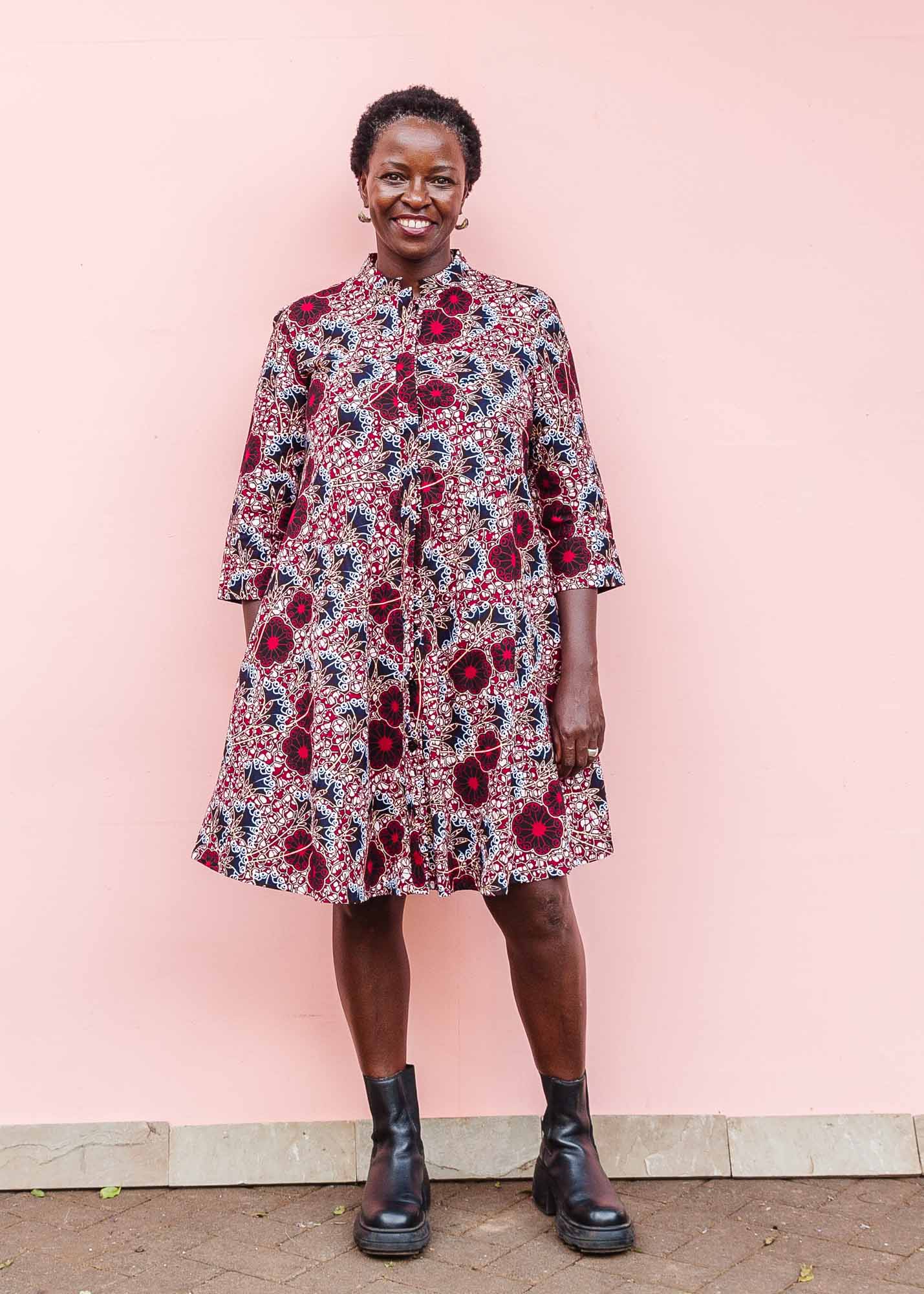 The model is wearing  Burgundy, white and navy blue floral print dress
