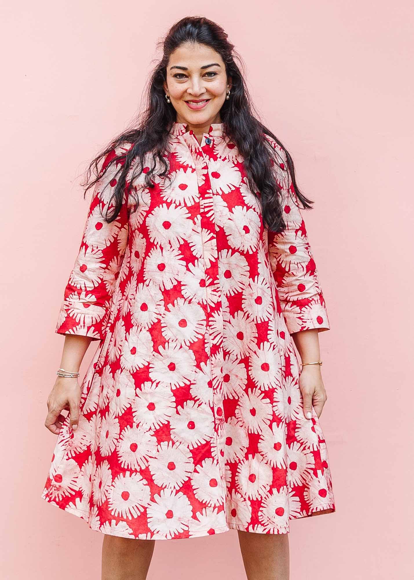 The model is wearing pink and white floral print dress