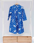 Display of blue dress with white fishes and polka dots.