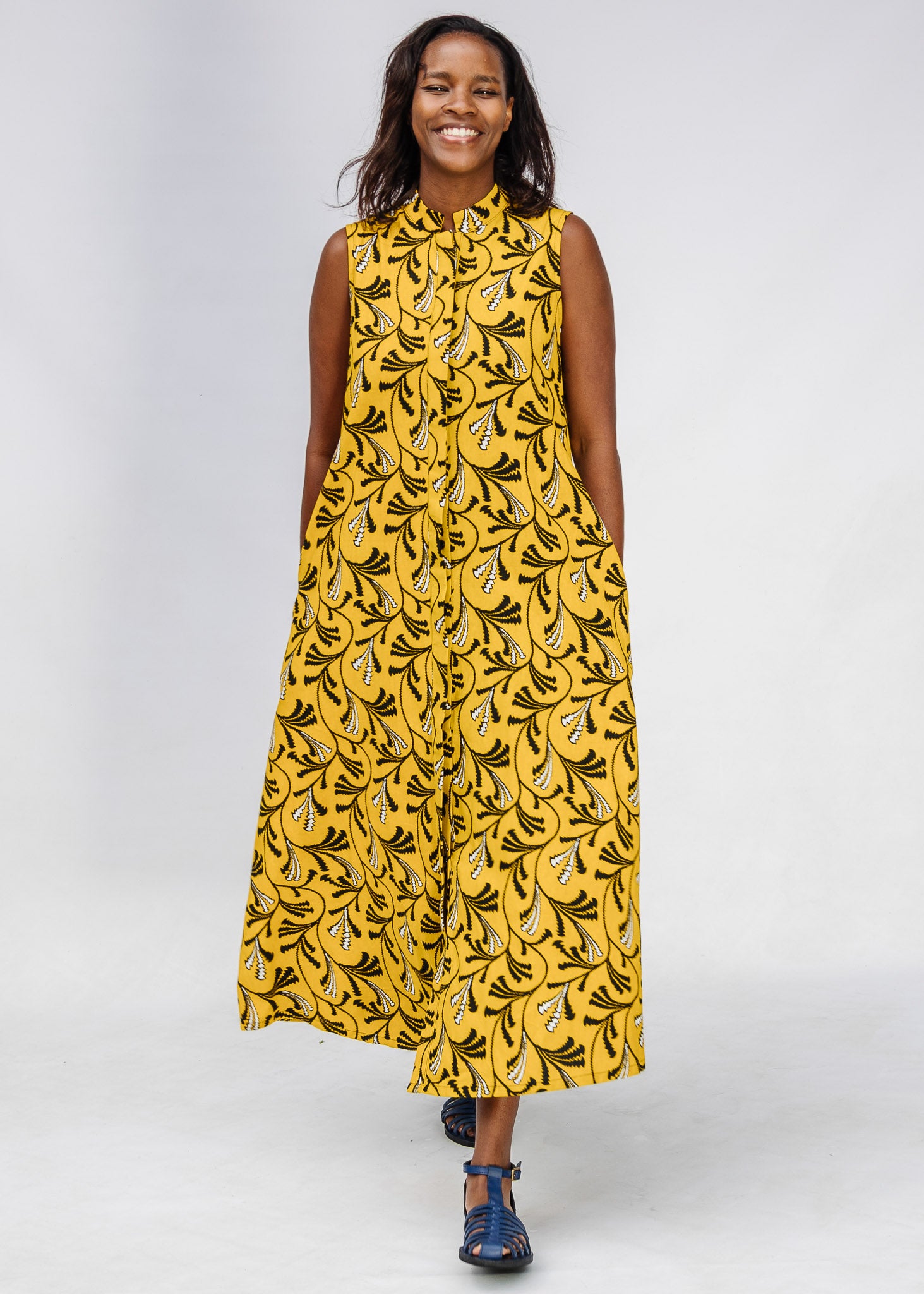 Model wearing yellow dress with black and white paisley print.
