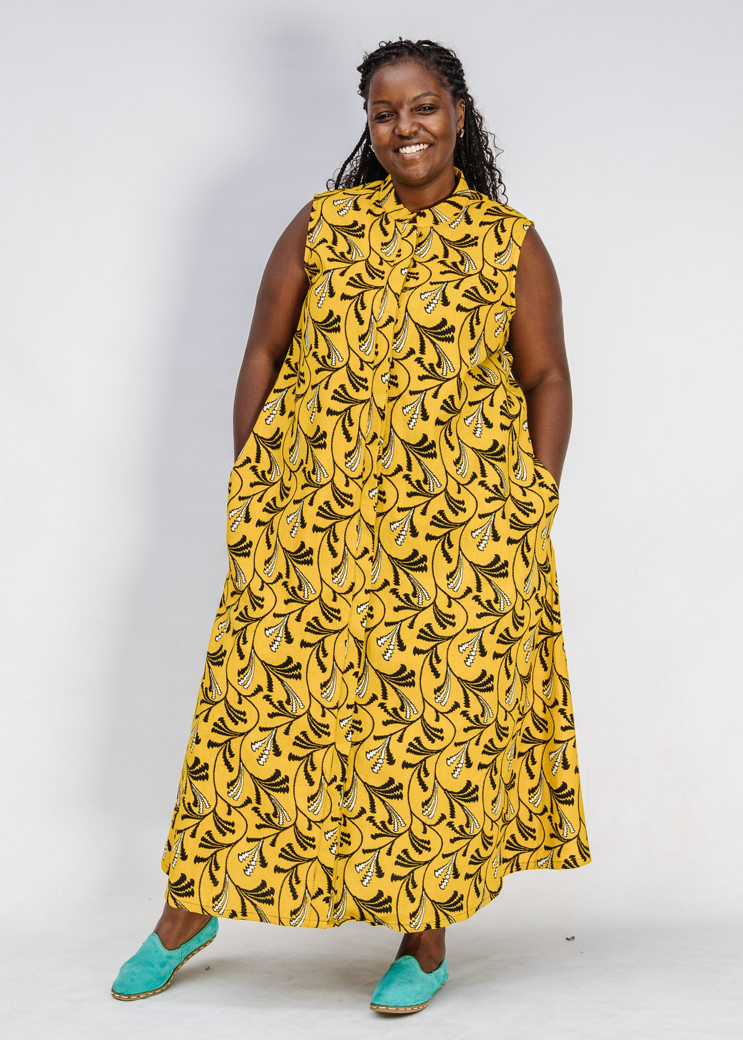 Model wearing yellow dress with black and white paisley print.