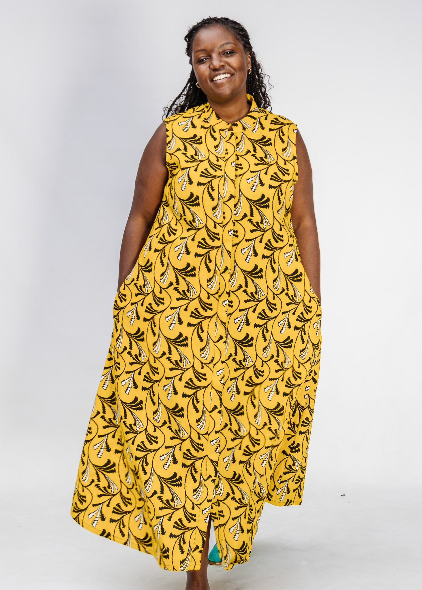 Model wearing yellow dress with black and white paisley print.