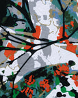 Close up display of green, grey, white, orange and black abstract print, fabric.