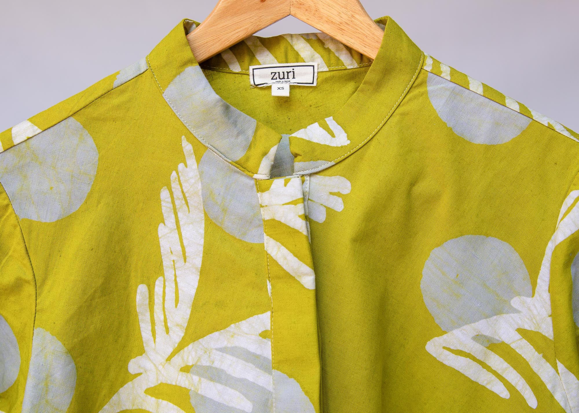 Display of olive-green, white and green batik dress