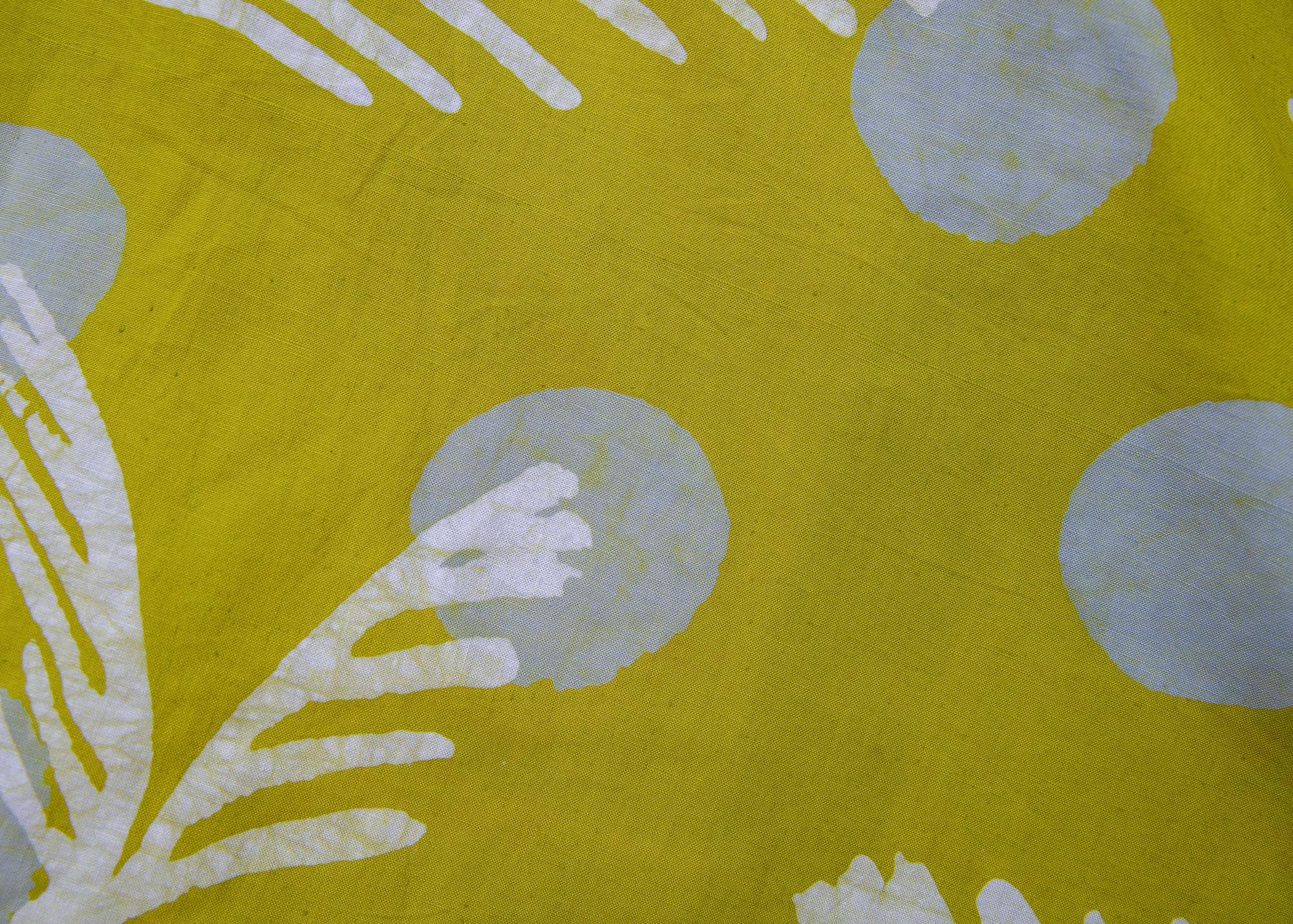 Close up display of olive-green, white and green batik dress