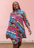 The model is wearing colorful mandala print dress