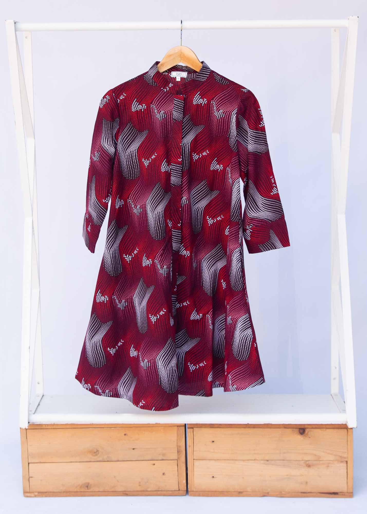 Display of merlot red, brown, red , coral and white abstract line print dress