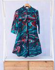 Display of turquoise, black, slate, white and red abstract print dress