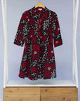 Display of red, white, and black floral print dress.
