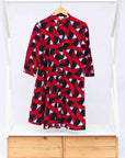 Display of red, black and white ribbon print dress.