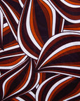 Display of brown, orange, and white abstract print dress.