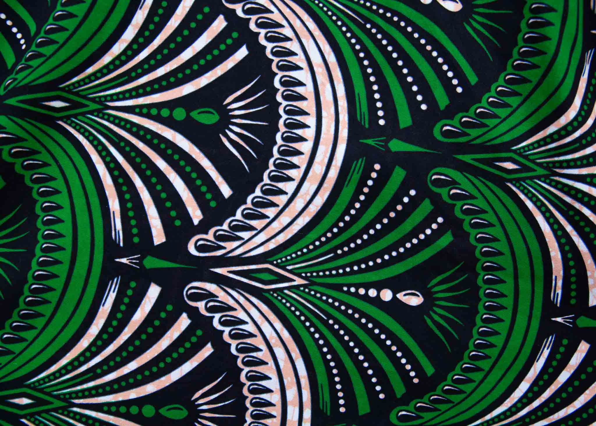 Display of green, white and black abstract print dress.
