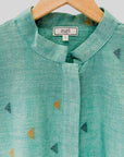 display of a green triangle design shirt