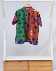 Display of green, orange and pink multiprint shirt.